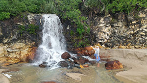 Shantara at waterfall on Onemana beach in New Zealand 2017 (photo by Virochana)